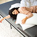 Woman laying on pillows and mattress